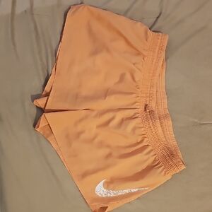 Nike Peach-Orange Athletic Shorts with White Swoosh